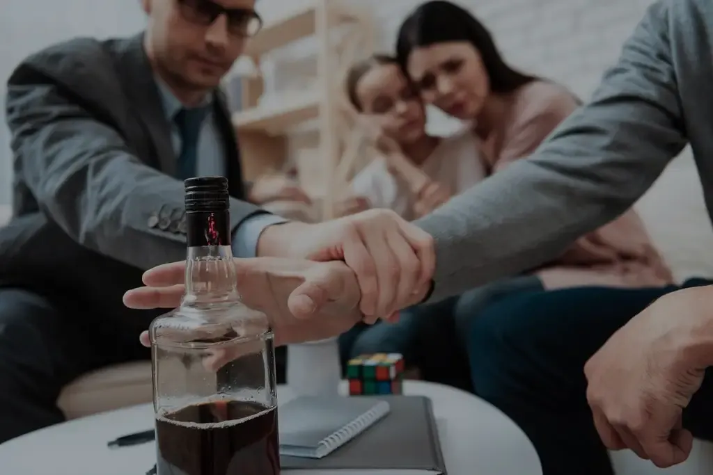 Family members sitting together while one gently reaches out to another